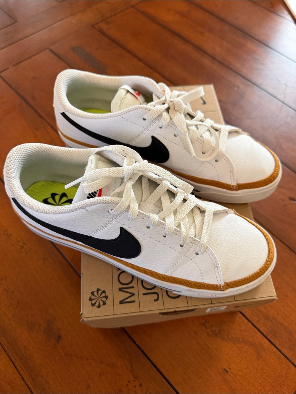 Nike White Sneakers with Black Swoosh and Tan Accent